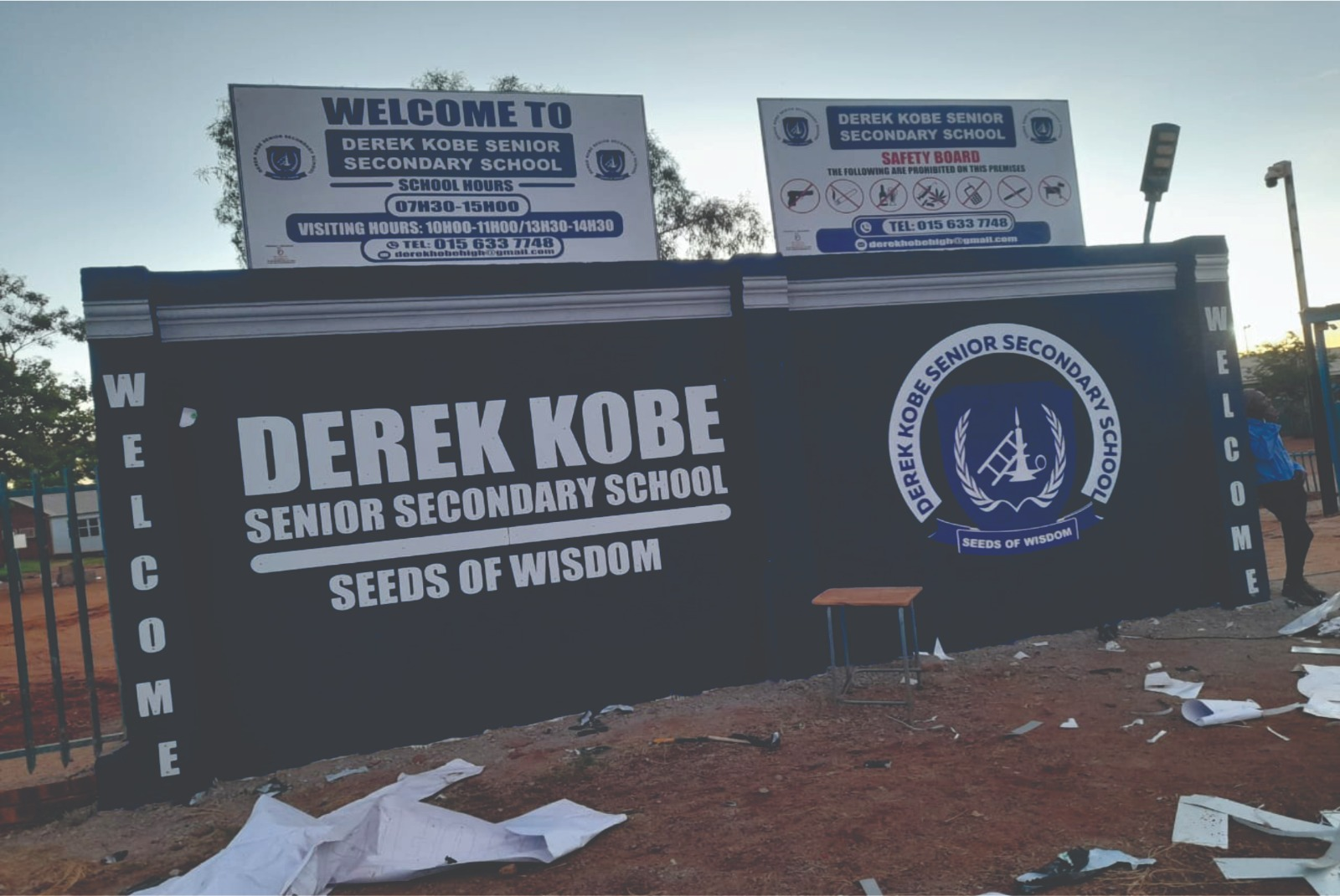 Derek Kobe Senior Secondary School branded boundary wall with school crest and welcome boards